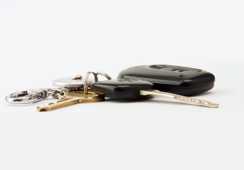 Car keys and a key fob resting on a light surface